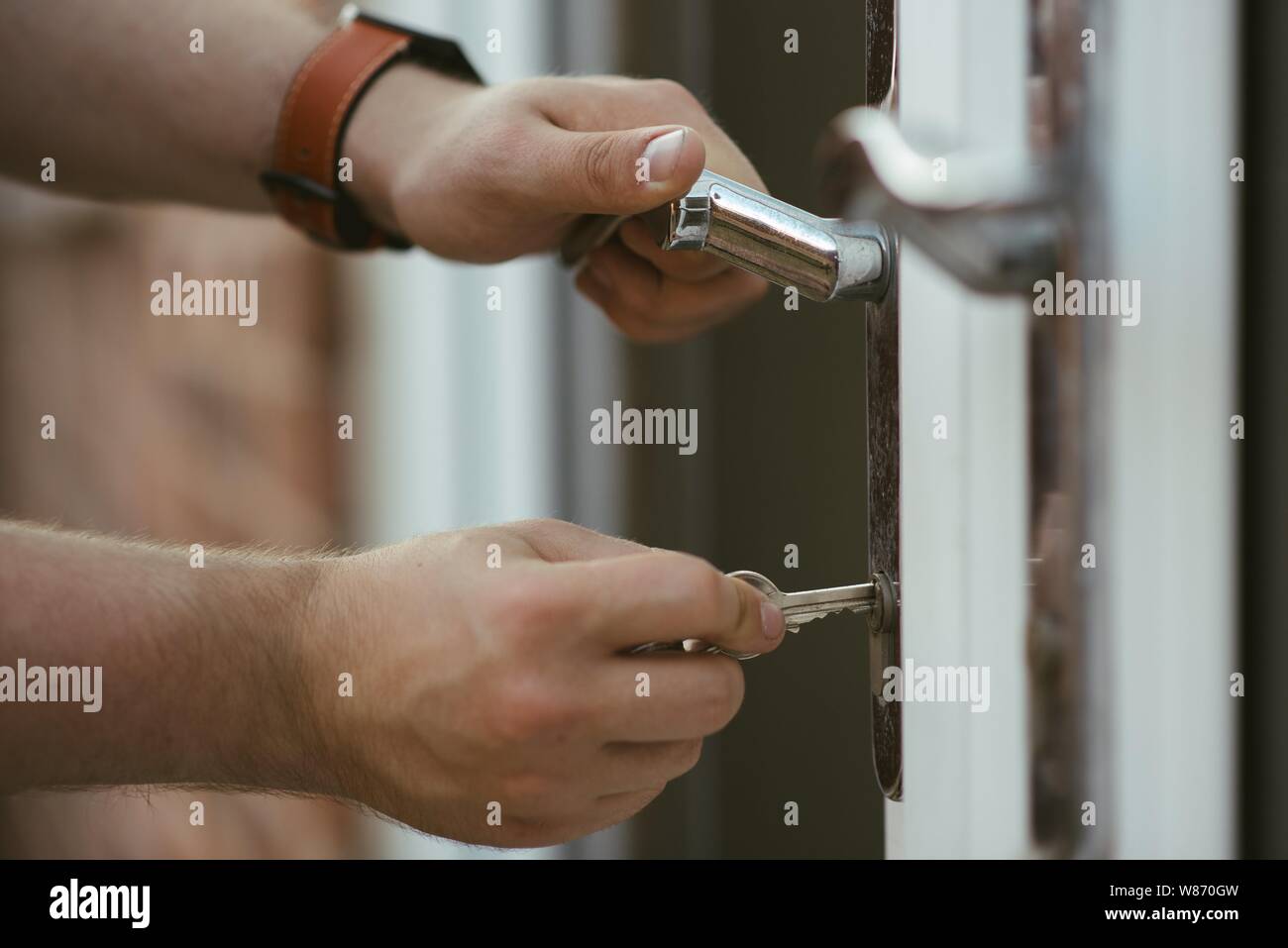 A Closeup Shot Of A Person Holding A Door Knob And Opening The