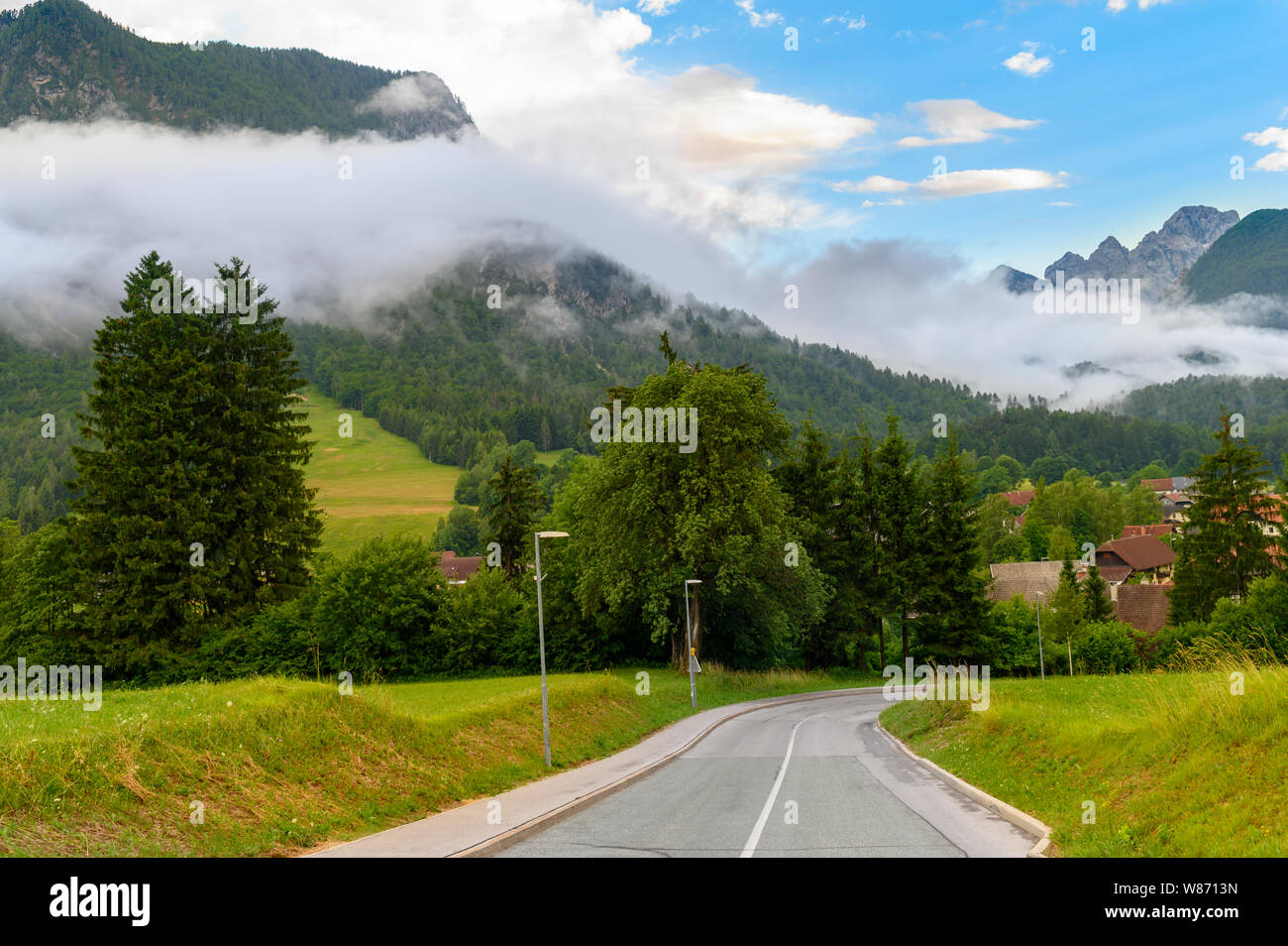 Sinuous road in mountains, cloudscape scenery Stock Photo
