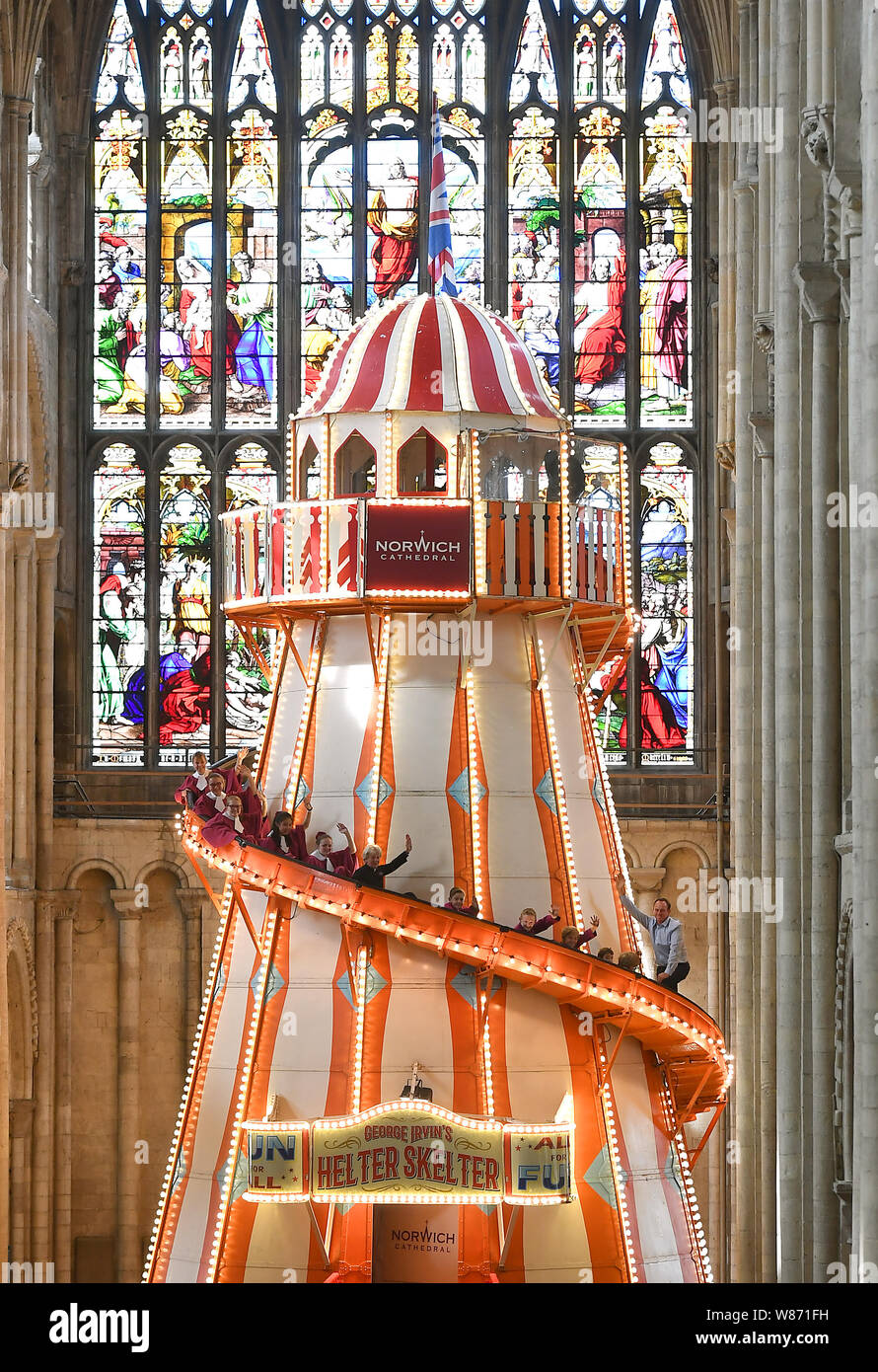Choristers from Norwich Cathedral choir goes down a 40ft helter skelter installed inside Norwich Cathedral as part of the Seeing It Differently project which aims to give people the chance to experience the Cathedral in an entirely new way and open up conversations about faith. Stock Photo