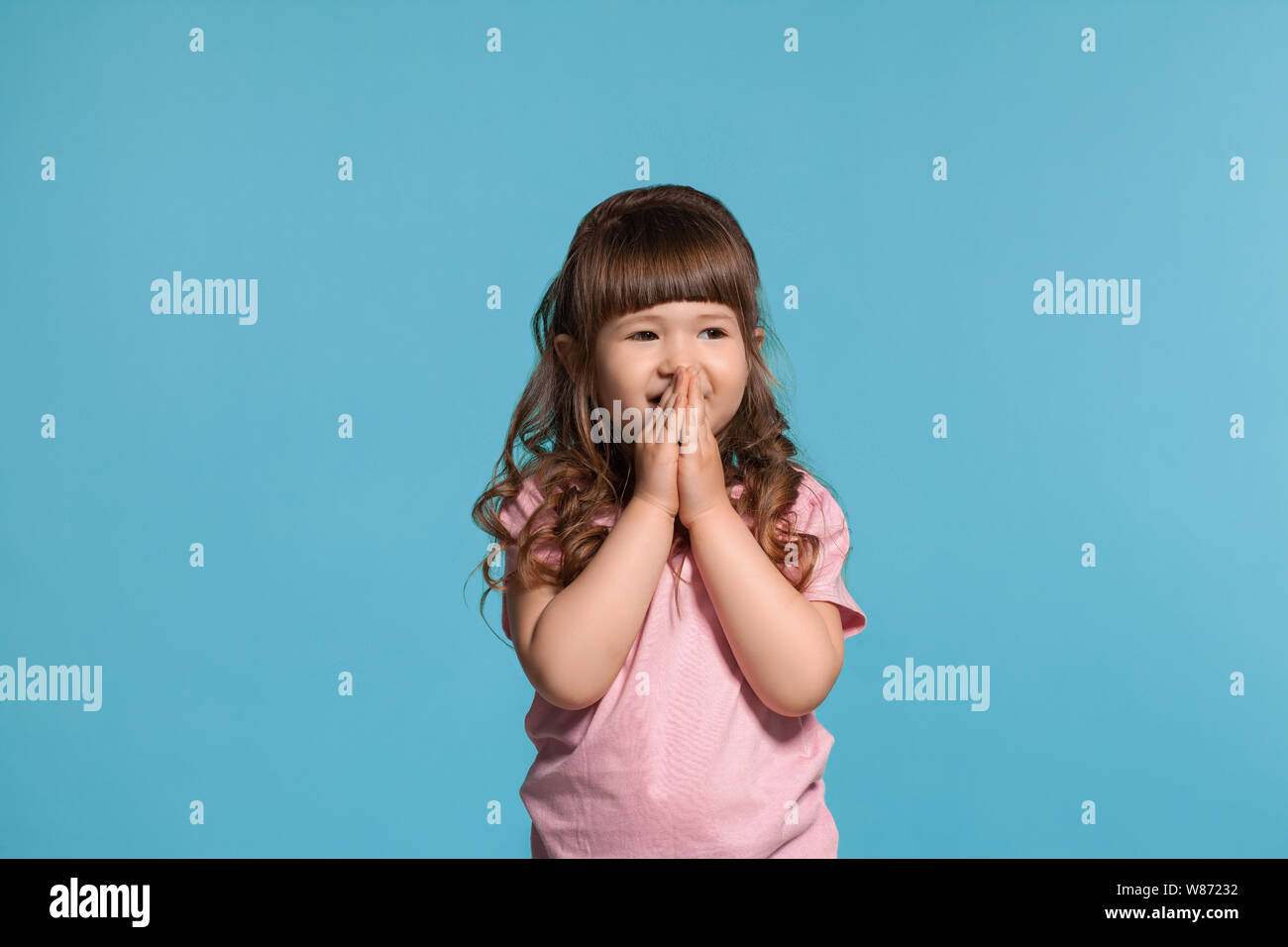 beautiful-little-girl-wearing-in-a-pink-t-shirt-is-posing-against-a