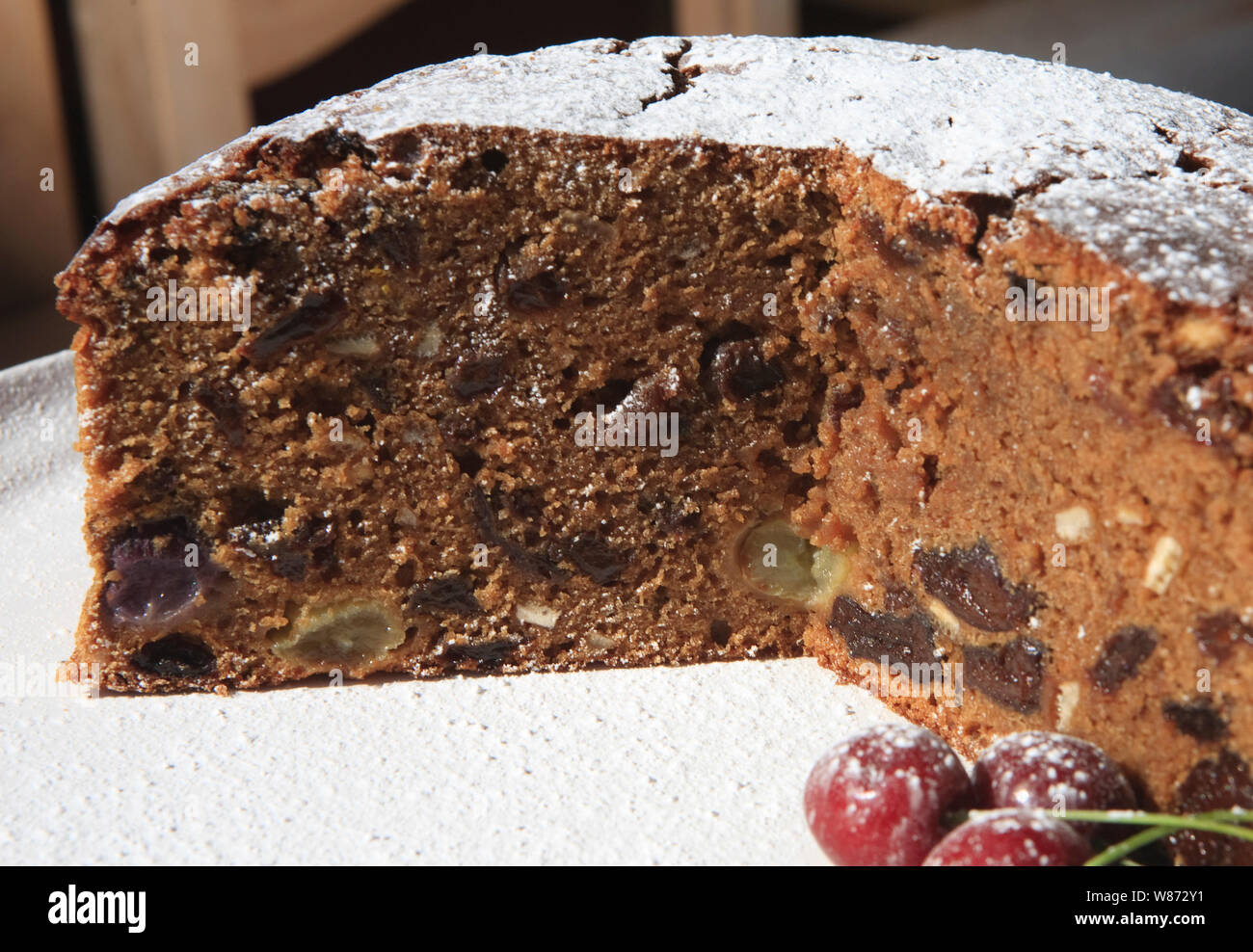 freshly baked fruit and nut cake dusted with icing sugar Stock Photo