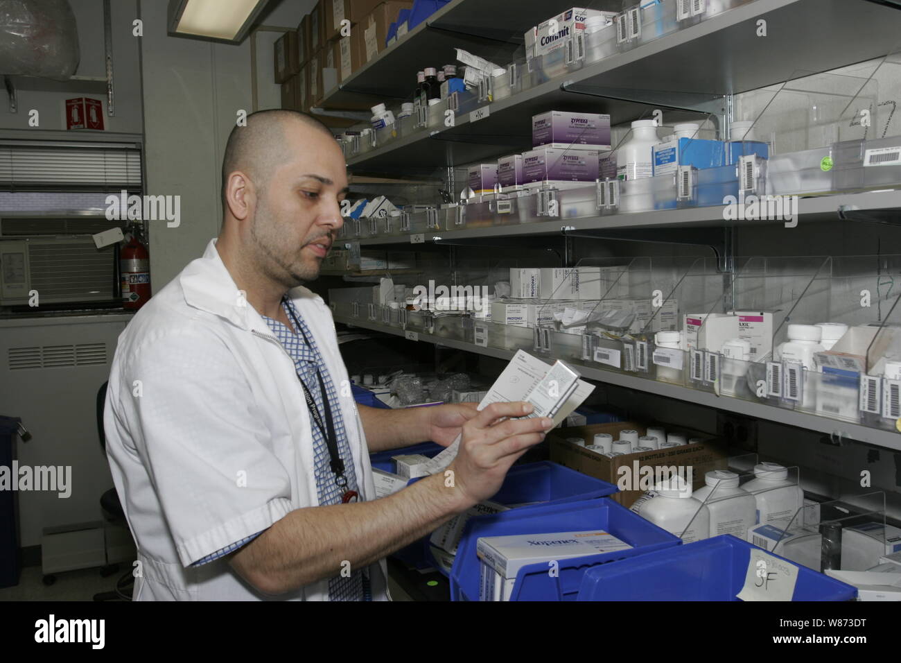 Pharmacist fills orders for patients at a hospital pharmacy, New York