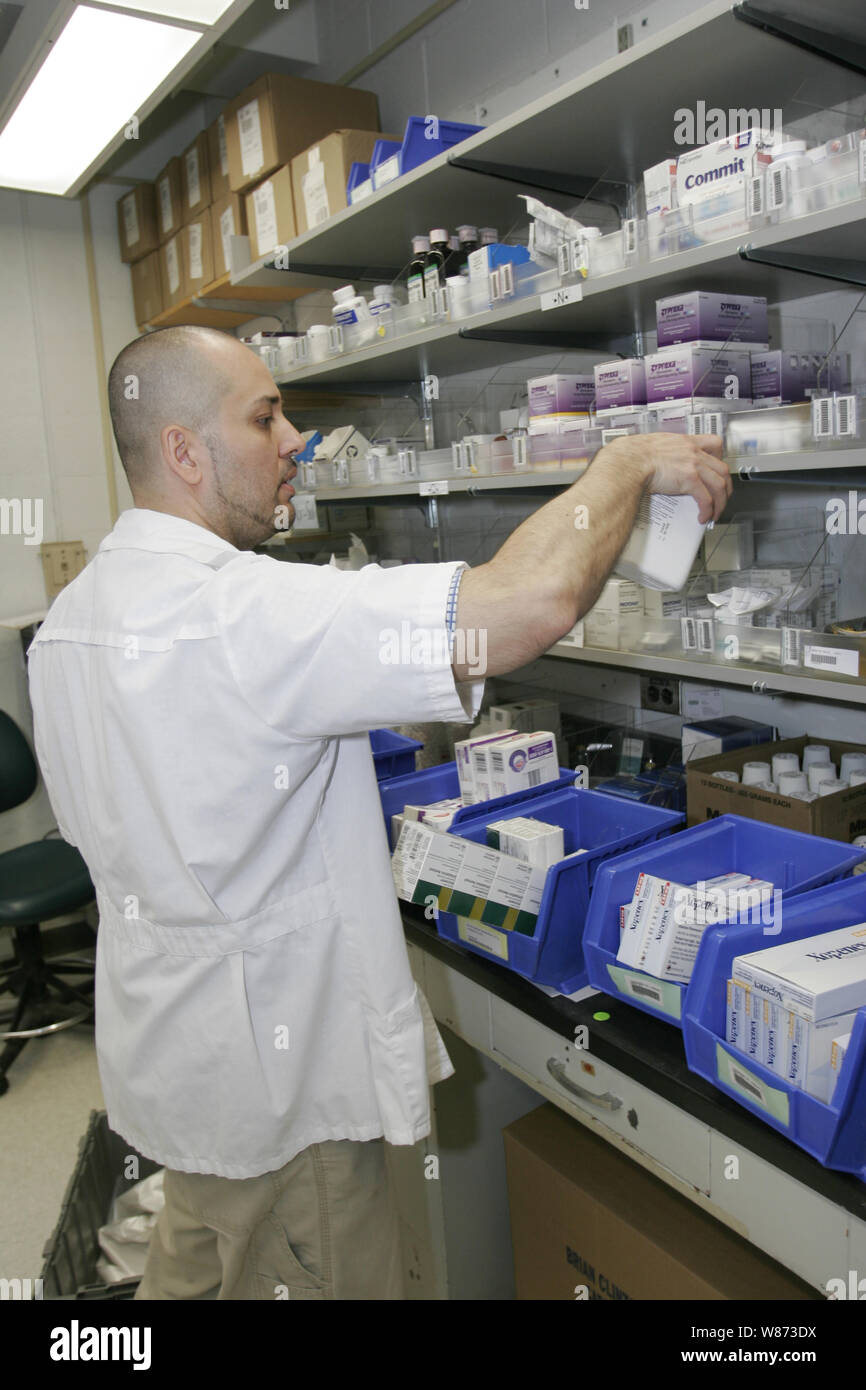 Pharmacist fills orders for patients at a hospital pharmacy, New York