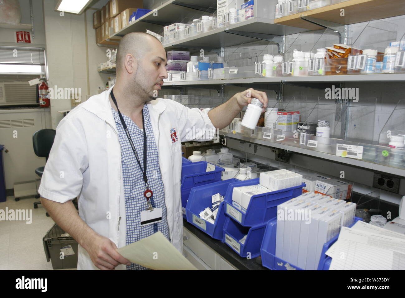 Pharmacist fills orders for patients at a hospital pharmacy, New York
