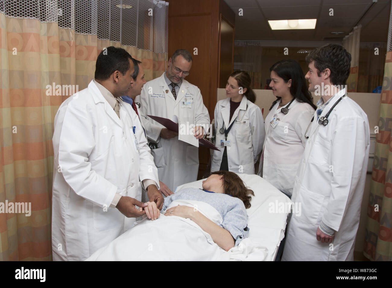 Doctor with interns doing "Grand Rounds" on a patient floor at a NY