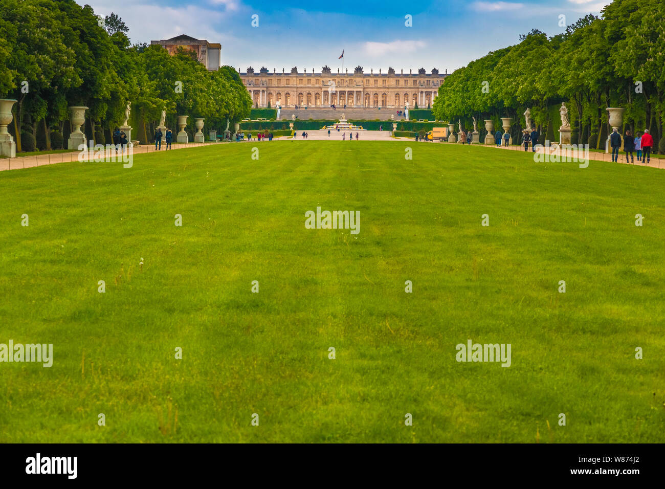 Nice panoramic landscape view of the garden façade of the famous Palace of Versailles from the large lawn or green carpet (Tapis Vert) between the... Stock Photo