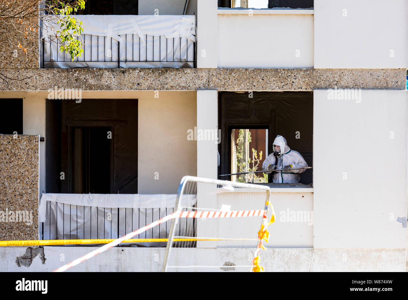 Montpellier (southern France): asbestos removal and demolition of an old building. Asbestos removal worker wearing a protective suit and mask. Stock Photo