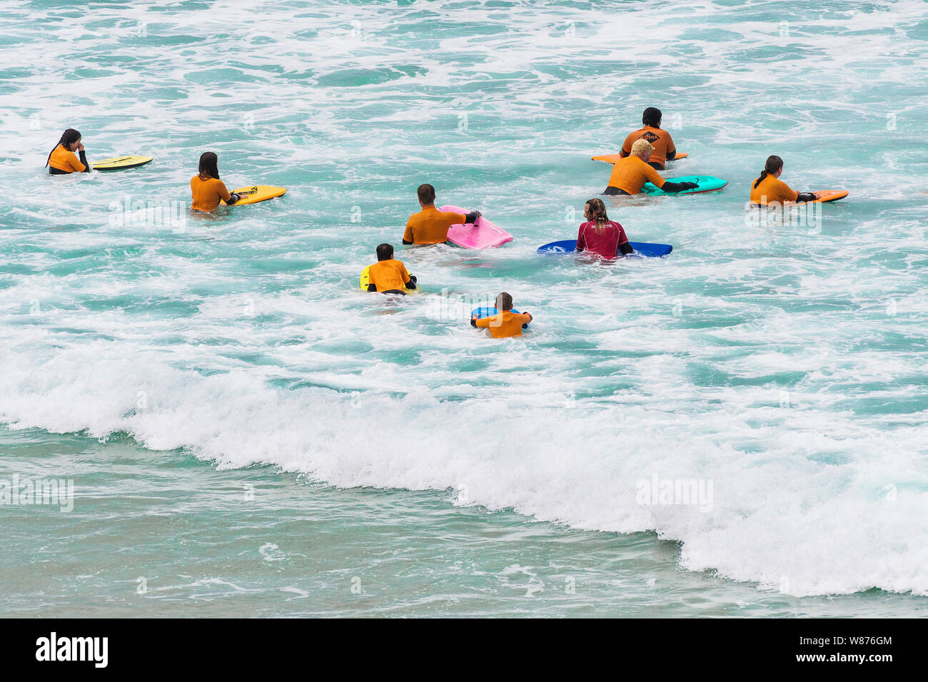 A body boogie boarding lesson at Great Gt Western Beach in Newquay in Cornwall. Stock Photo