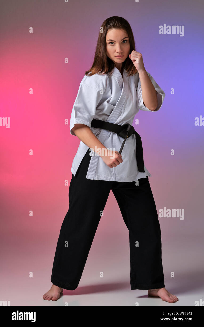 Athletic woman in traditional kimono is practicing karate in studio Stock  Photo - Alamy