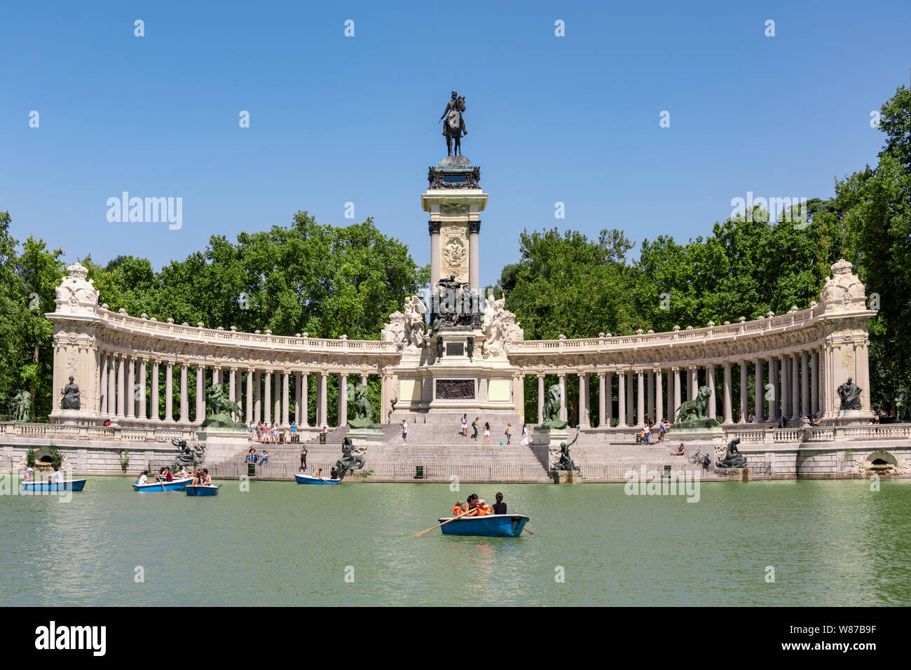 Horizontal view of the boating lake and Monument to King Alfonso XII at Retiro Park in Madrid. Stock Photo