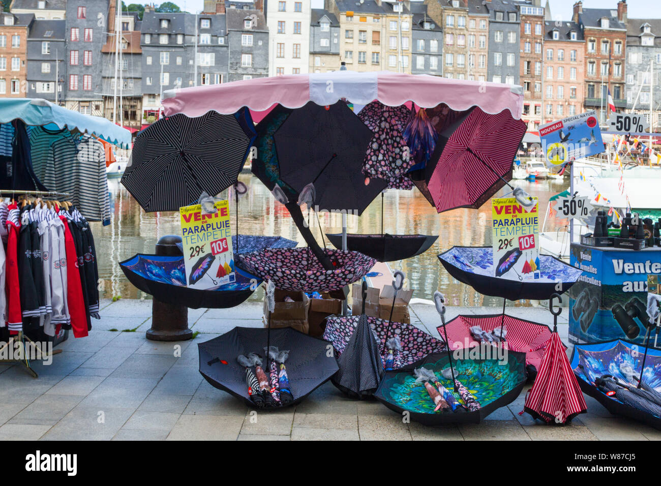 A colourful stall selling umbrellas by the old harbour at the Saturday market in Honfleur, Normandy, France Stock Photo