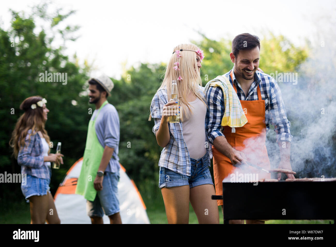 Group of happy friends having barbecue party in forest Stock Photo - Alamy