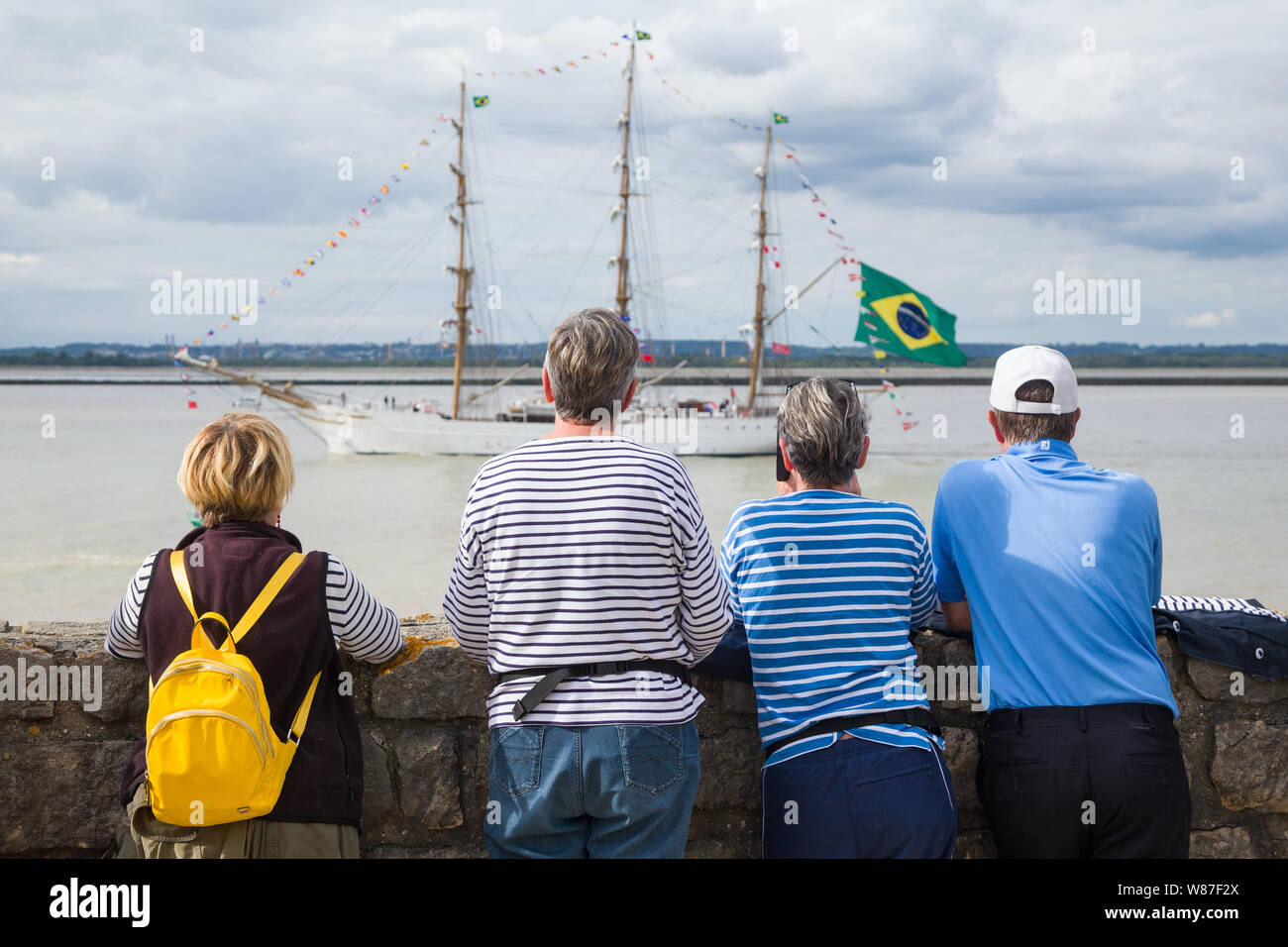 Spectators watch the tall ships returning from the Rouen Armada pass by at Honfleur, Normandy, France Stock Photo