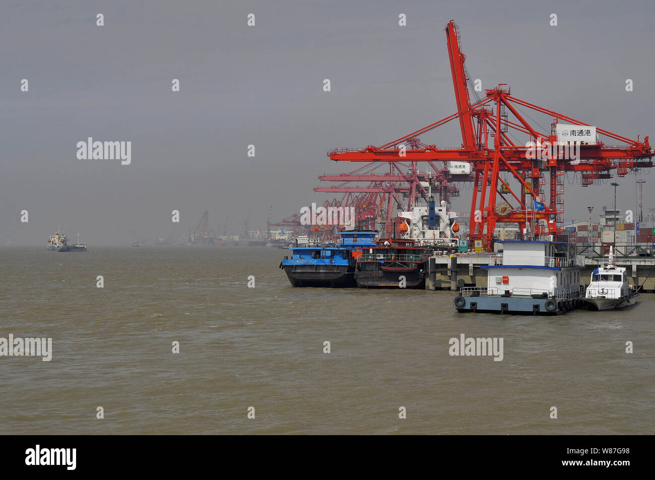 Container ships/boats at the Yangtse river quayside Nantong China Stock Photo