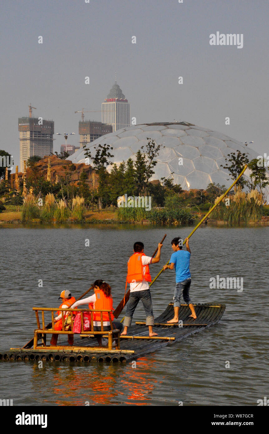 Tourists ride a bamboo raft on a boat lake in Nantong China Stock Photo