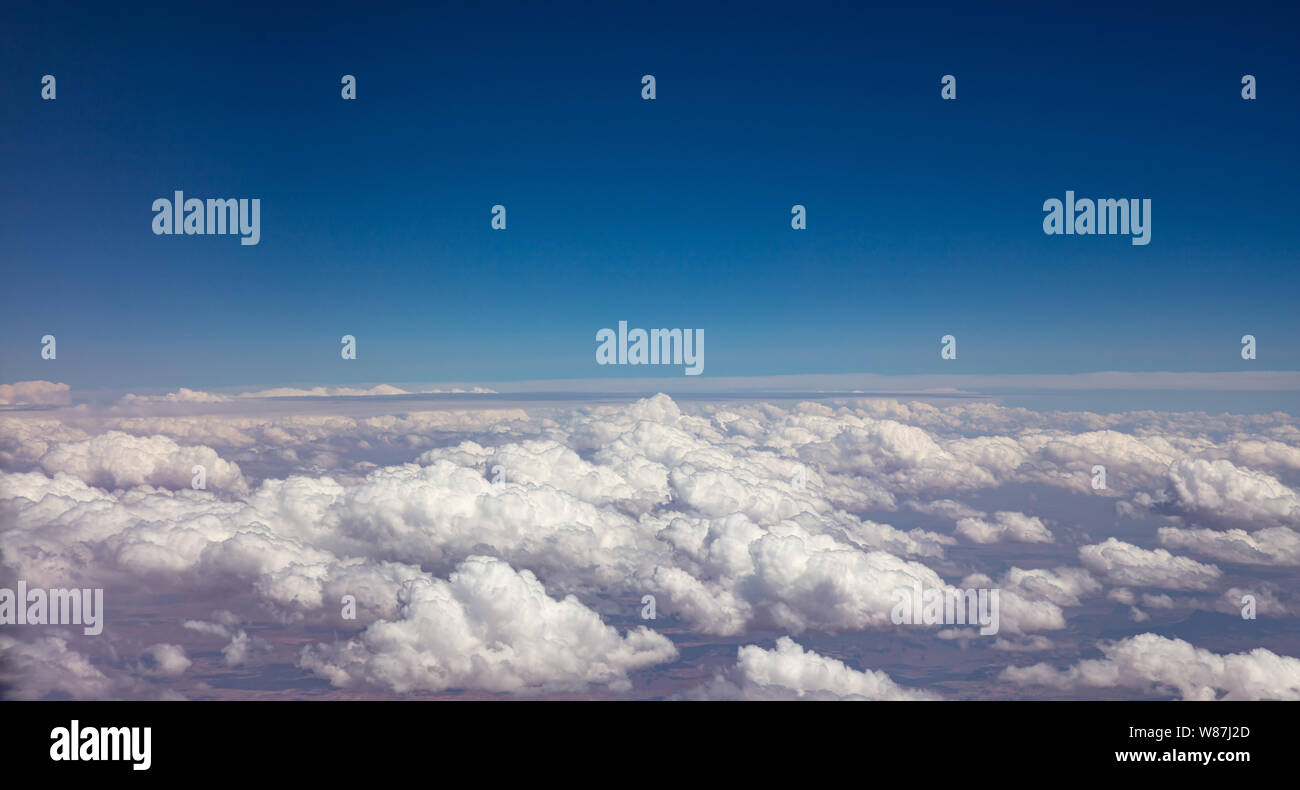 Cloudscape background. Blue sky and fluffy clouds Aerial view out of an ...