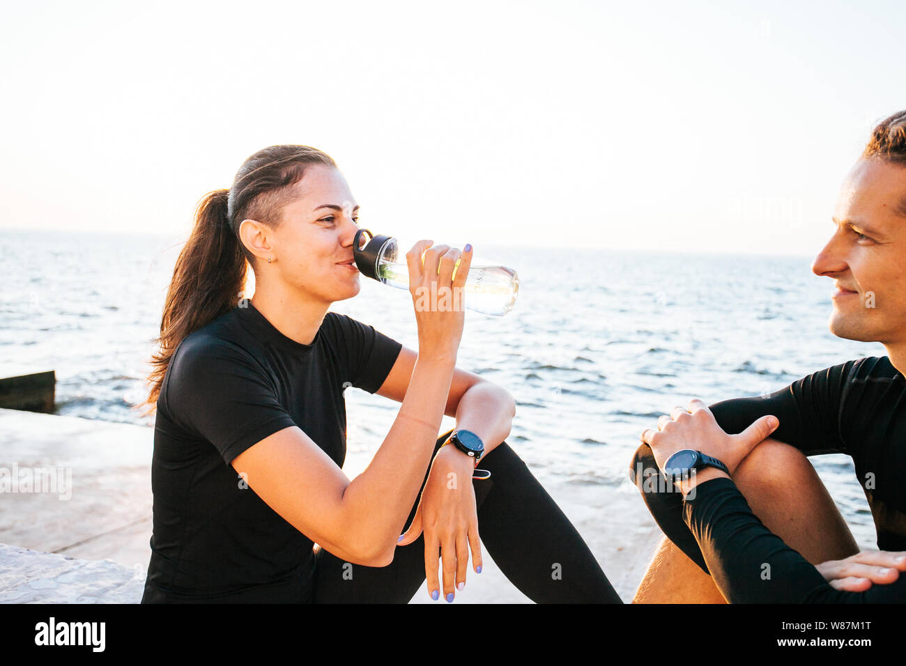 Young couple enjoying together after working out outdoors Stock Photo