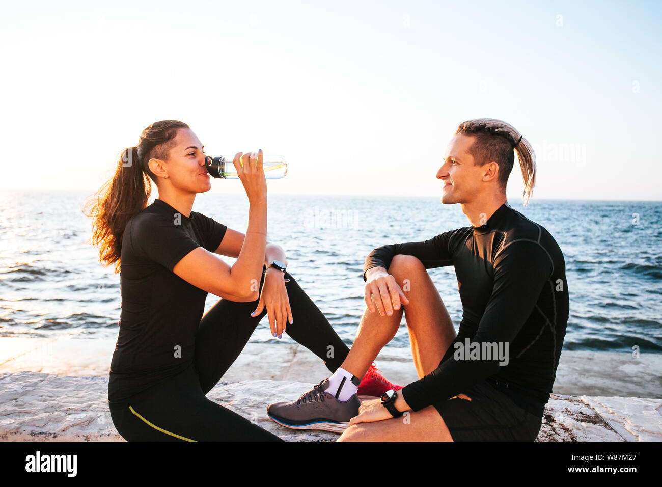 Young couple enjoying together after working out outdoors Stock Photo