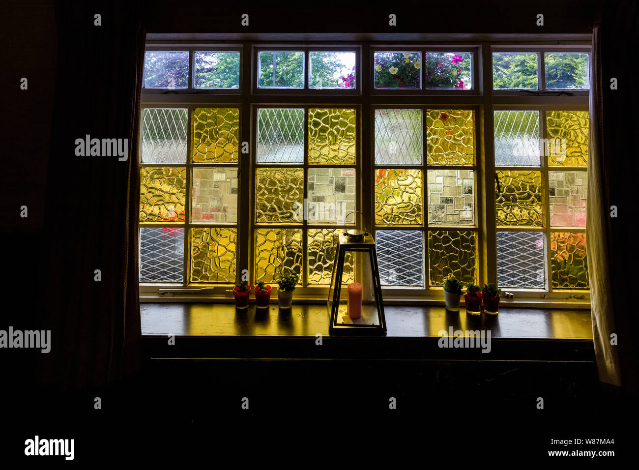 Colorful glass window in Corleys Abbey Lodge in Ballintubber County Mayo Irelnad Stock Photo