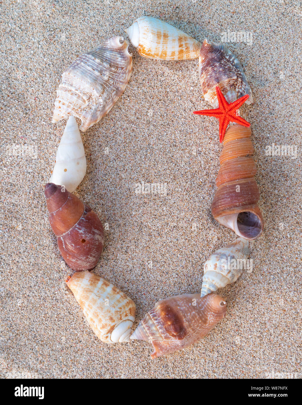 Calendar on sand. Year 2020. Seashells forming 0 inscription on yellow ...