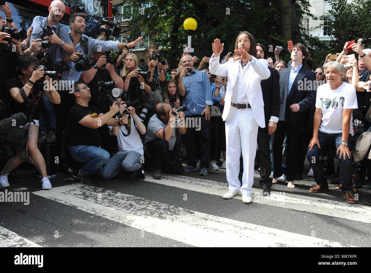 Abbey Road crossing, NW8, London, UK. Thursday, 8th August, 2019. The Beatles tribute band walk across the zebra crossing in Abbey Road to celebrate the album Abbey Road's 50th anniversary. Credit: David Bronstein/Alamy News Stock Photo
