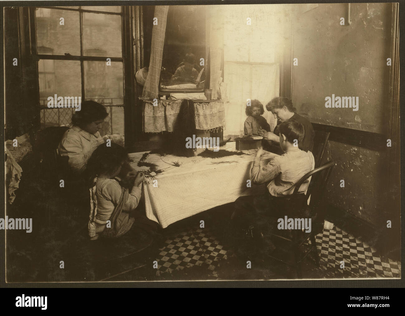 5 P.M. Mrs. Mary Molinari and family, 304 E. 107th St. We made feathers some, but not much. Six-year-old Antoinette ties like an old hand. Dominick, 9 years old, works some. Annie 9, the oldest girl, works in a shirt-waist factory. Father is a hod carrier. Stock Photo