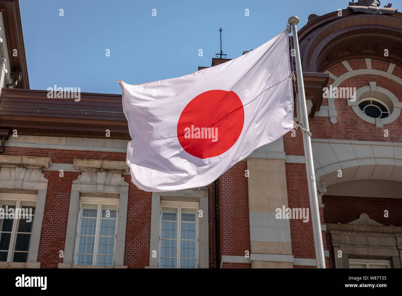 Japanese flag outside Tokyo Rail Station, Tokyo, Japan. Stock Photo