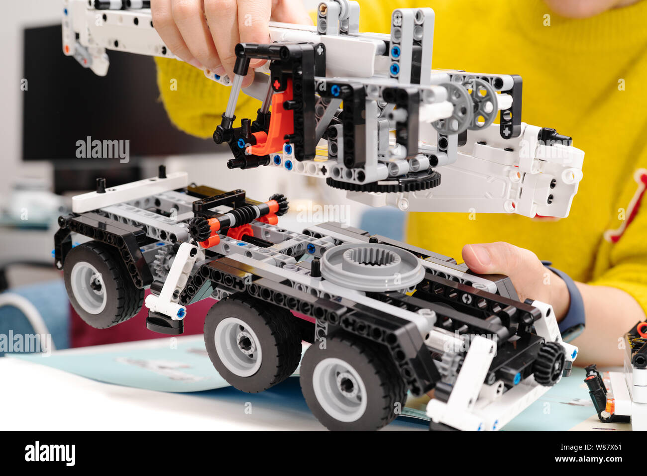 car assembly kit, woman assemble a very complicated and common car