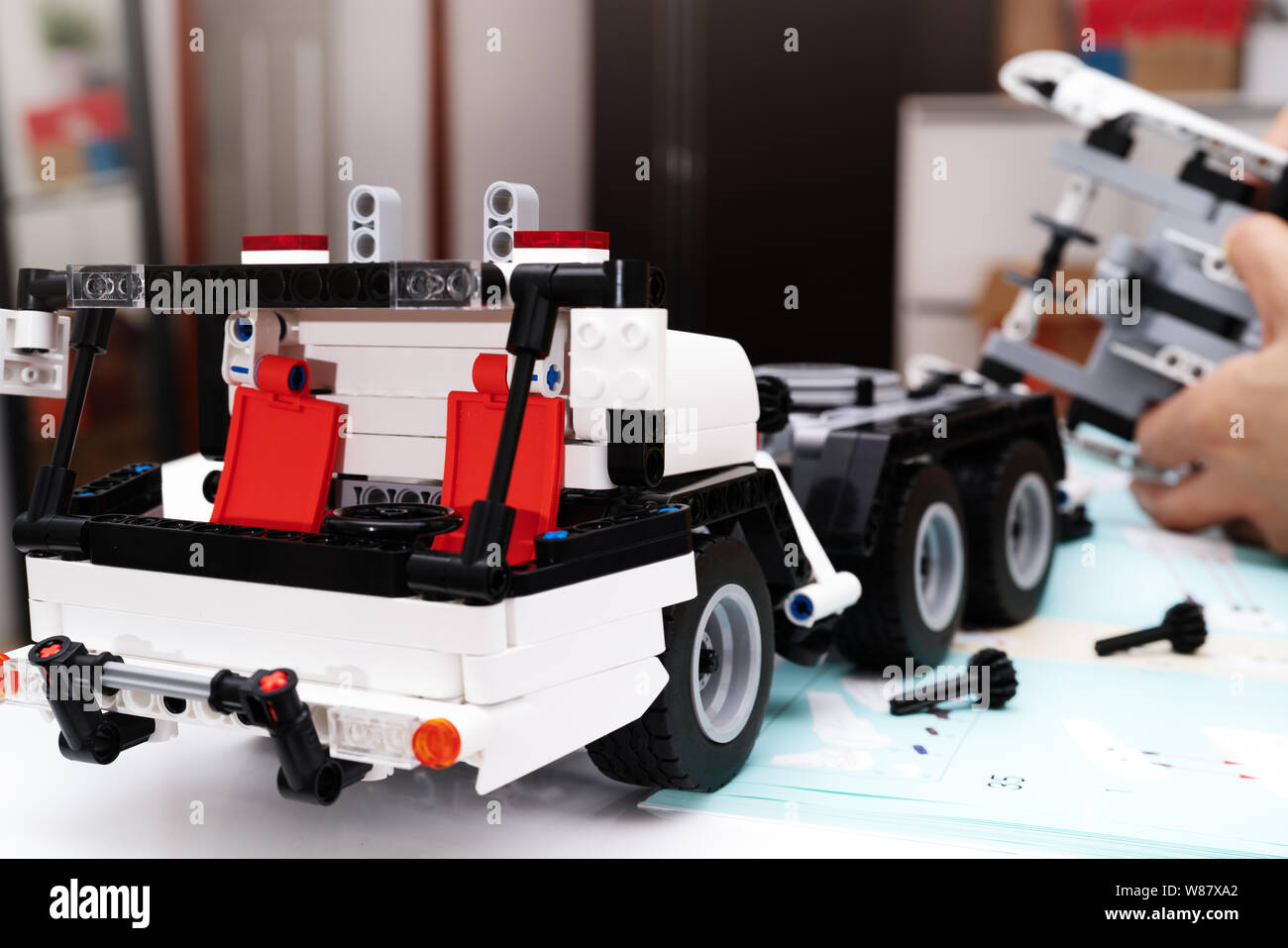 car assembly kit, woman assemble a very complicated and common car