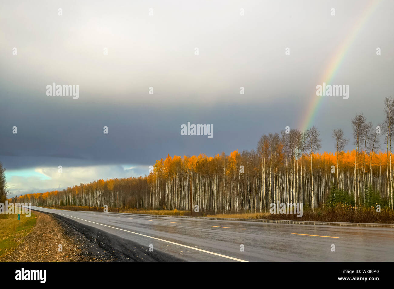 West pavement and rainbow at highway 881 south Fort McMurray, Alberta Canada Stock Photo