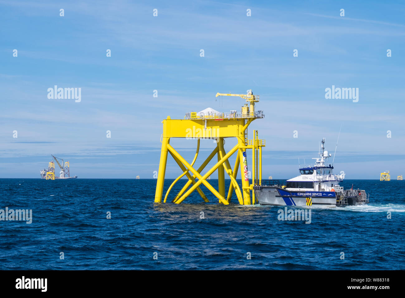 East Anglia ONE Offshore Wind Farm during construction with the heavy-lift construction vessel, Boka Lift, lifting one of the jackets in place Stock Photo