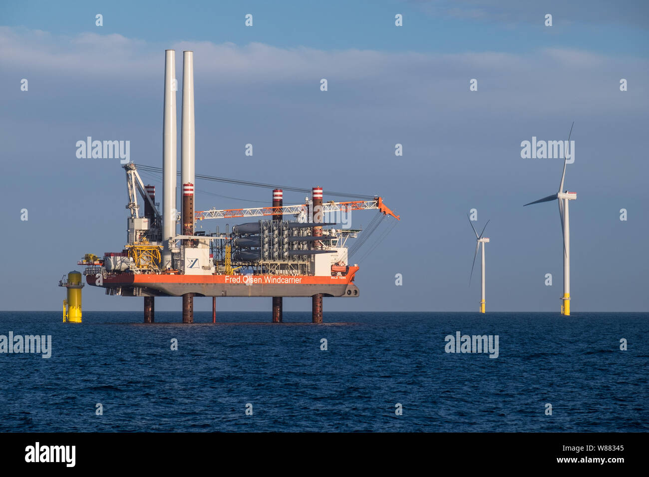 A wind turbine installation vessel, Bold Tern, working on erecting Siemens wind turbines on Hornsea Project One Offshore Wind Farm Stock Photo