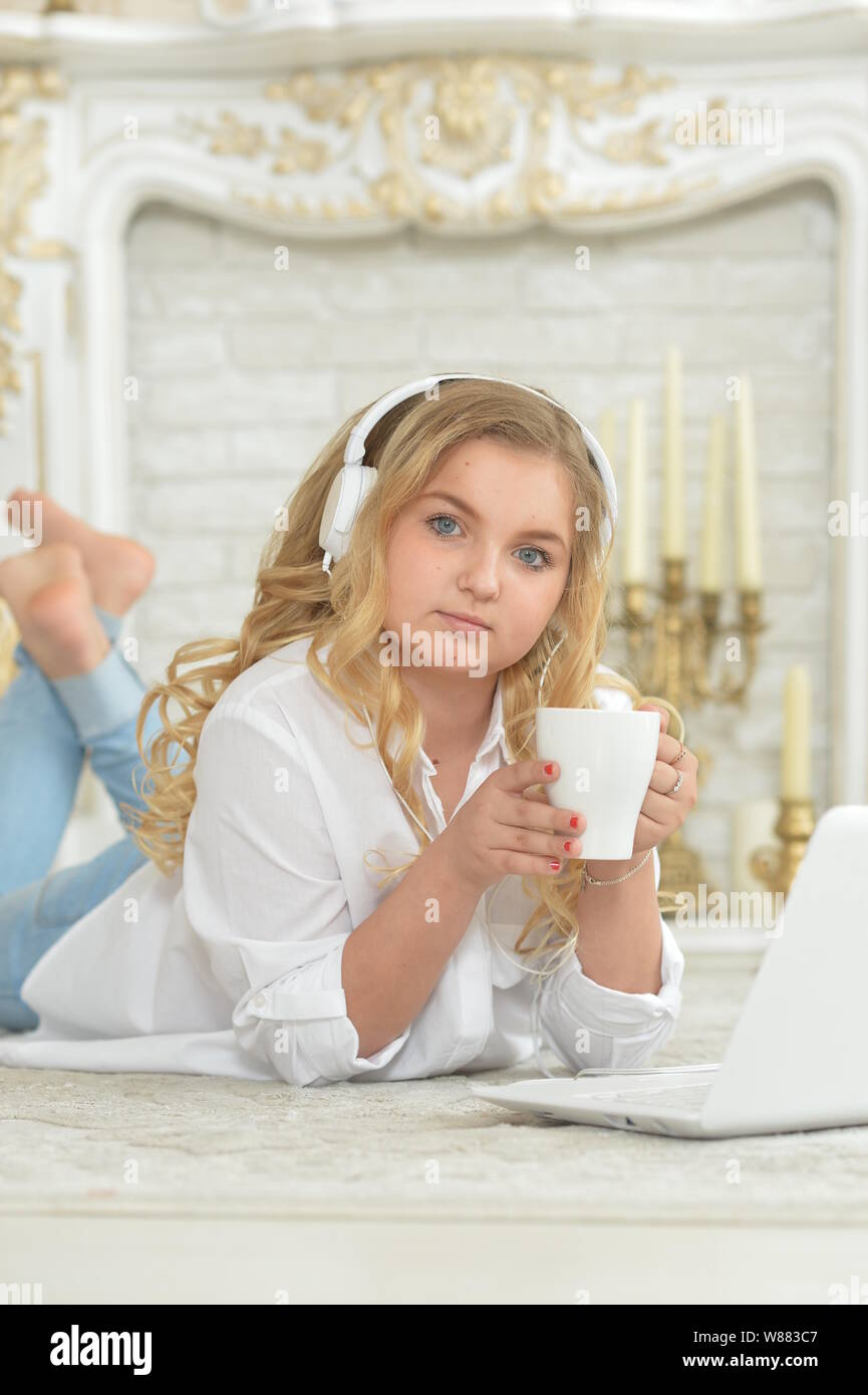 teenage girl in headphones lying on floor Stock Photo - Alamy