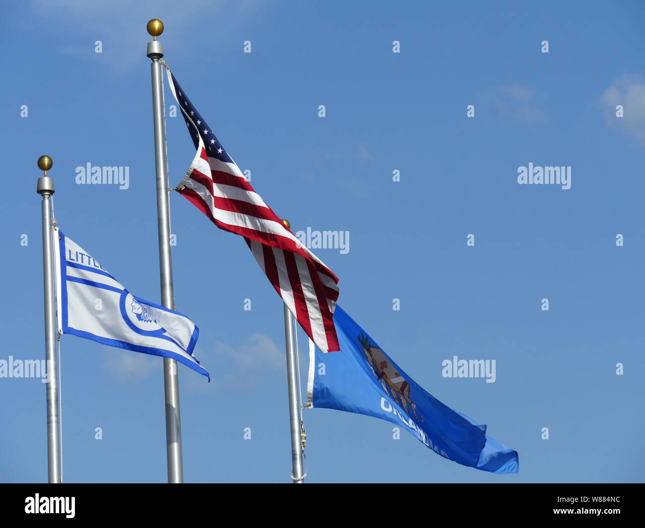 Upward shot of the flags of the United States, Oklahoma State and