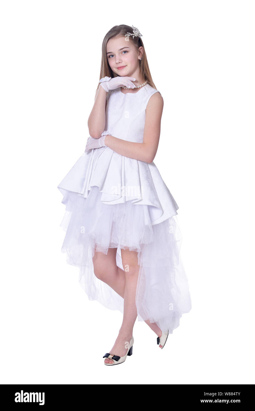 Happy beautiful little girl in white dress posing on white background ...
