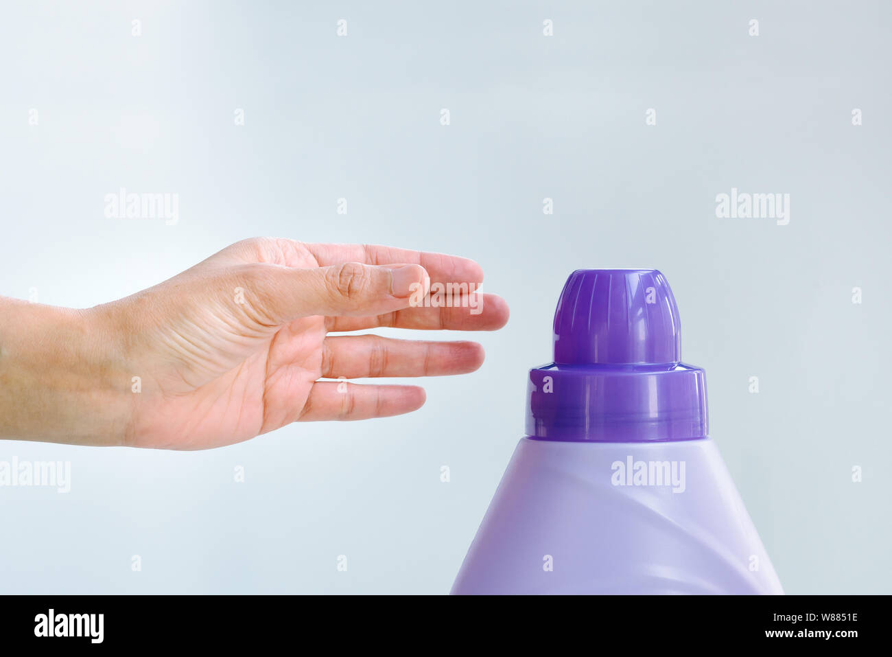 woman hand using liquid laundry softener detergent washing cloth Stock