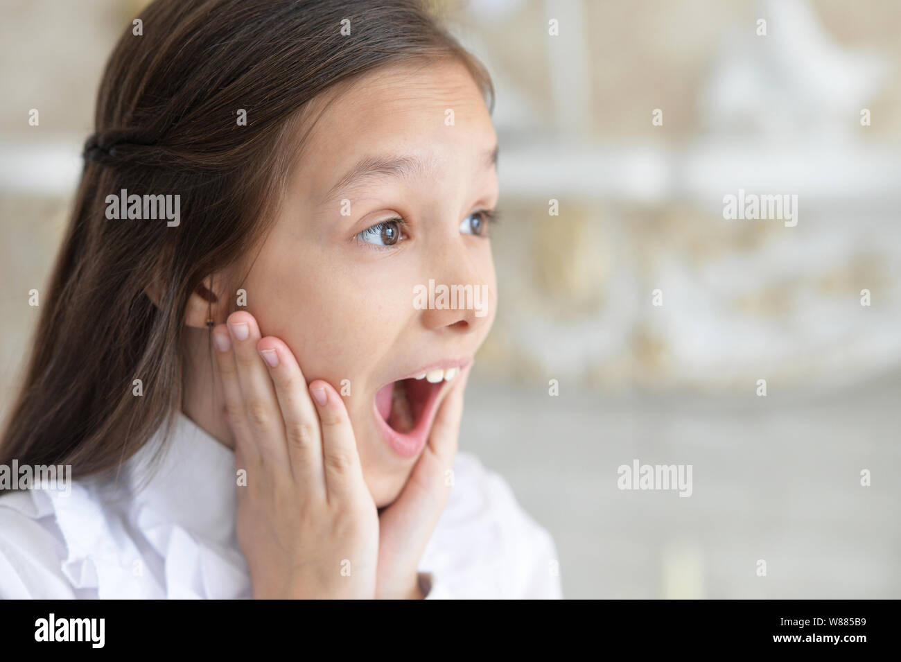 Portrait of emotional little girl in white blouse Stock Photo - Alamy
