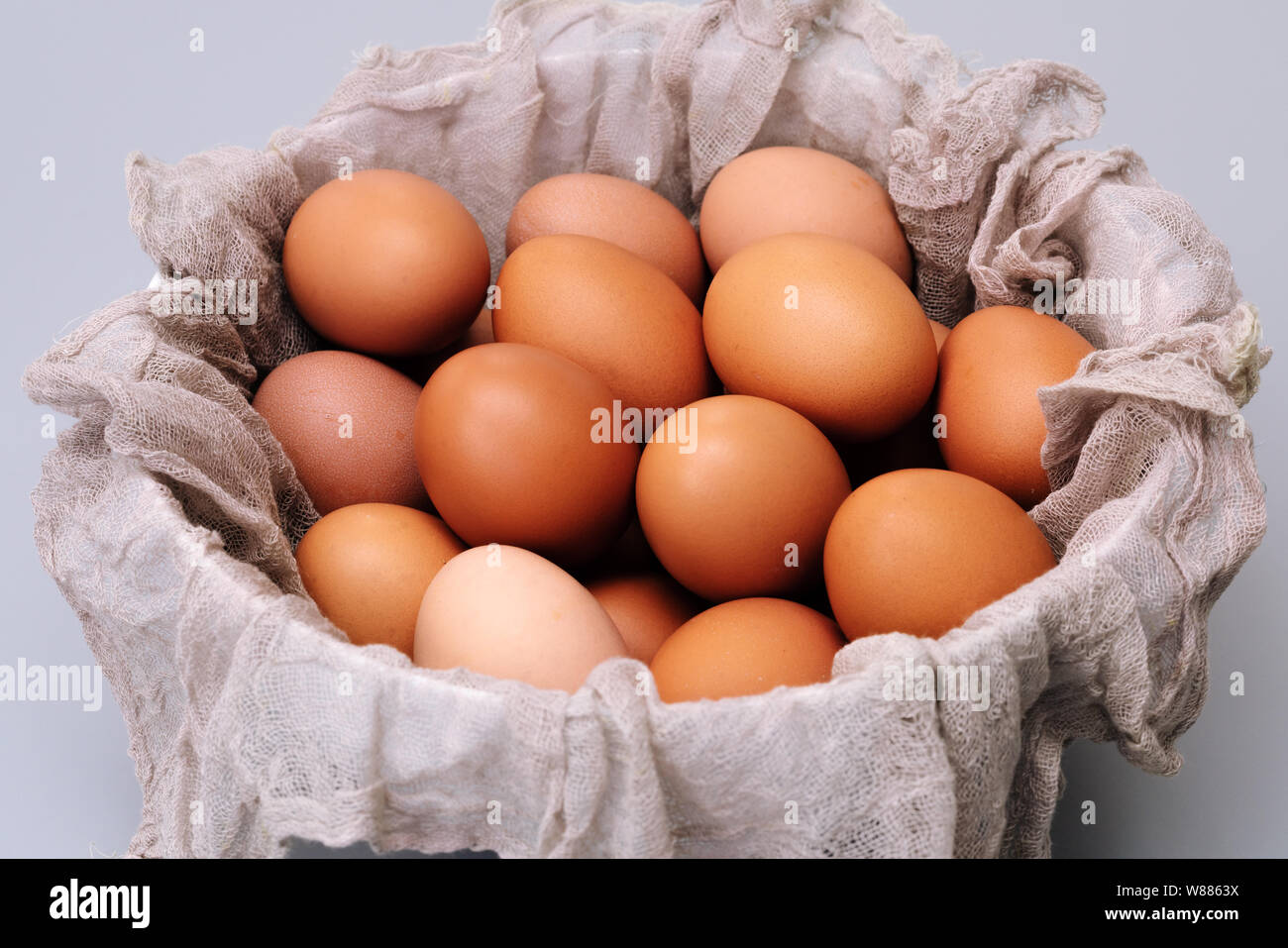 brown chicken eggs bowl on gray background, easter egg festive Stock Photo