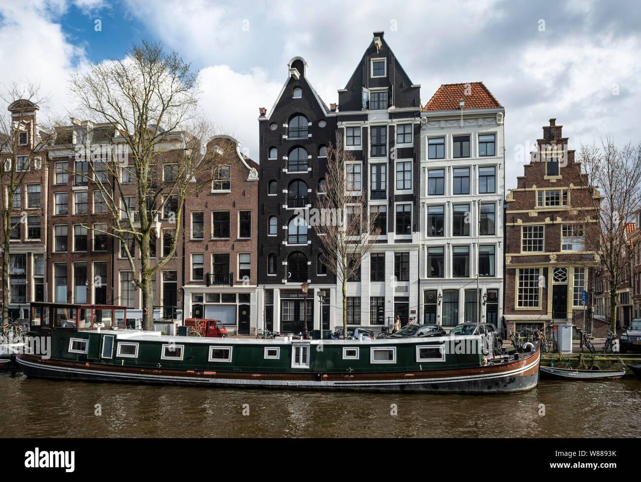 Canal with houseboat and historic houses, Amsterdam, North Holland, Holland, Netherlands Stock