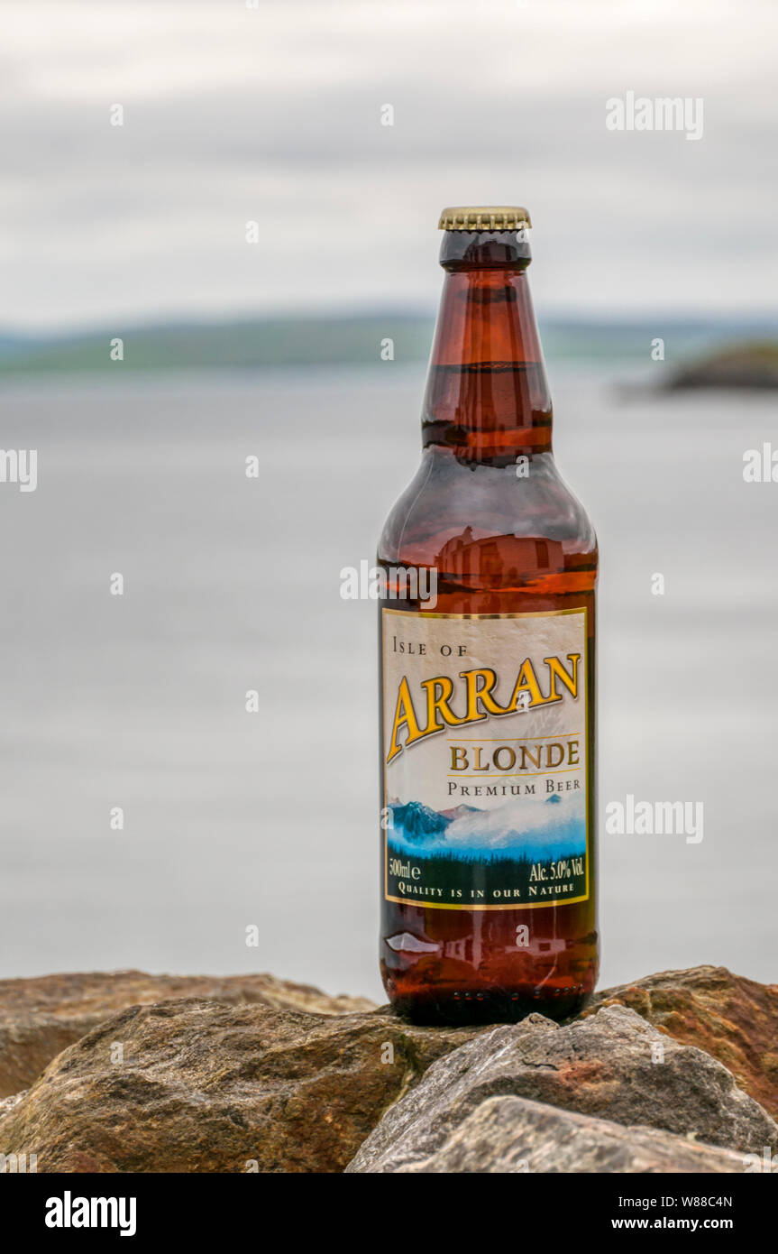 A bottle of Isle of Arran Blonde Premium Beer photographed in the Scottish countryside.  It has a strength of 5% ABV. Stock Photo