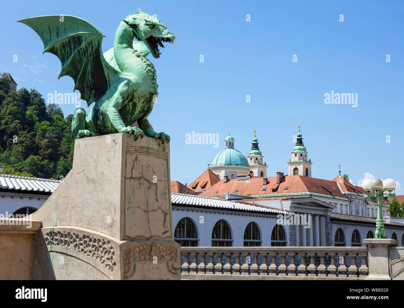 Dragon Bridge dragon statue on the Dragon bridge Zmajski most in front of the Ljubljana Cathedral  and central market Ljubljana Slovenia Eu Europe Stock Photo