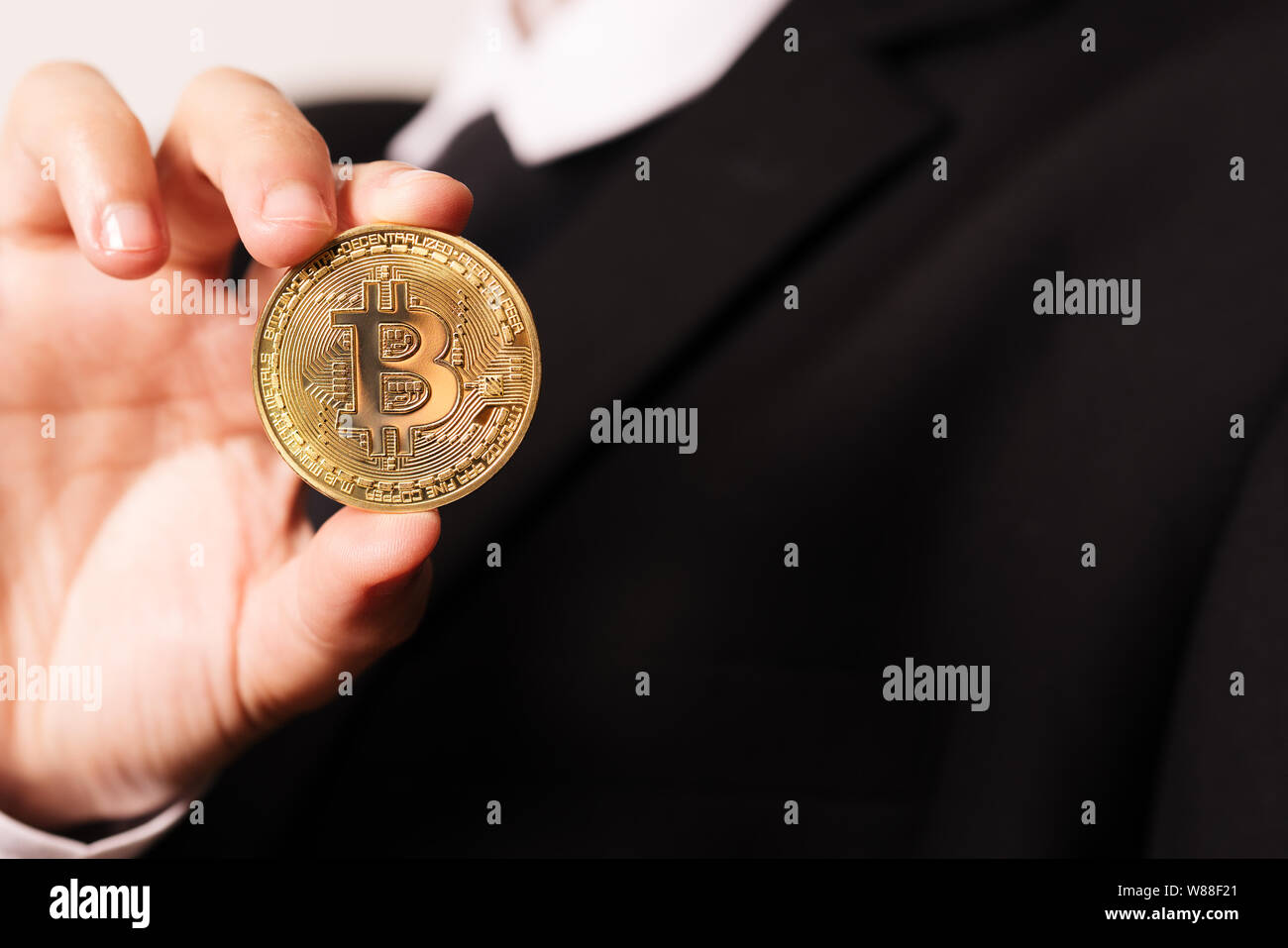 cryptocurrency Bitcoin. Women hold the cryptocurrency coin on hand.  Physical bitcoins gold coin Stock Photo - Alamy