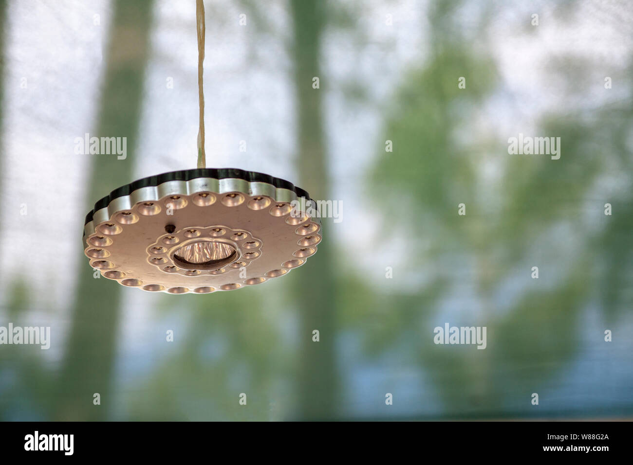 Tourist mobile LED flashlight hanging on a rope. Stock Photo