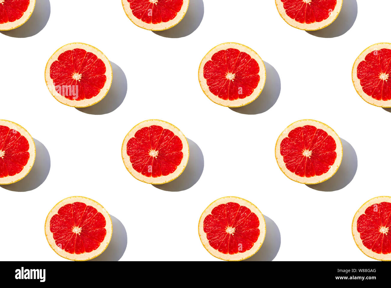 Grapefruit slices pattern isolated on white background. Minimal flat lay concept. Stock Photo