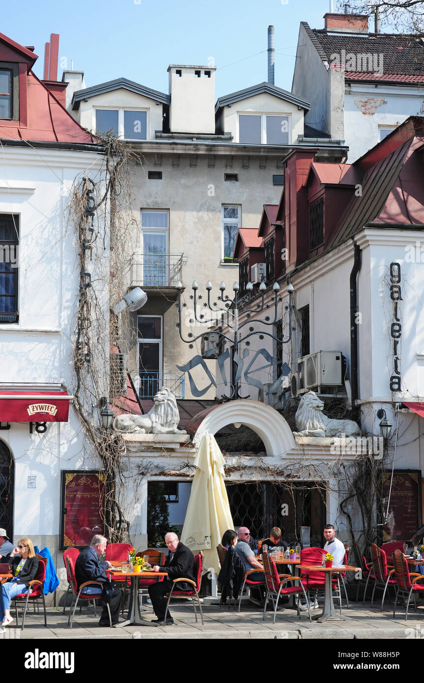 People eating outside in the Jewish Quarter, Kazimierz, Krakow.  The Menora. Stock Photo