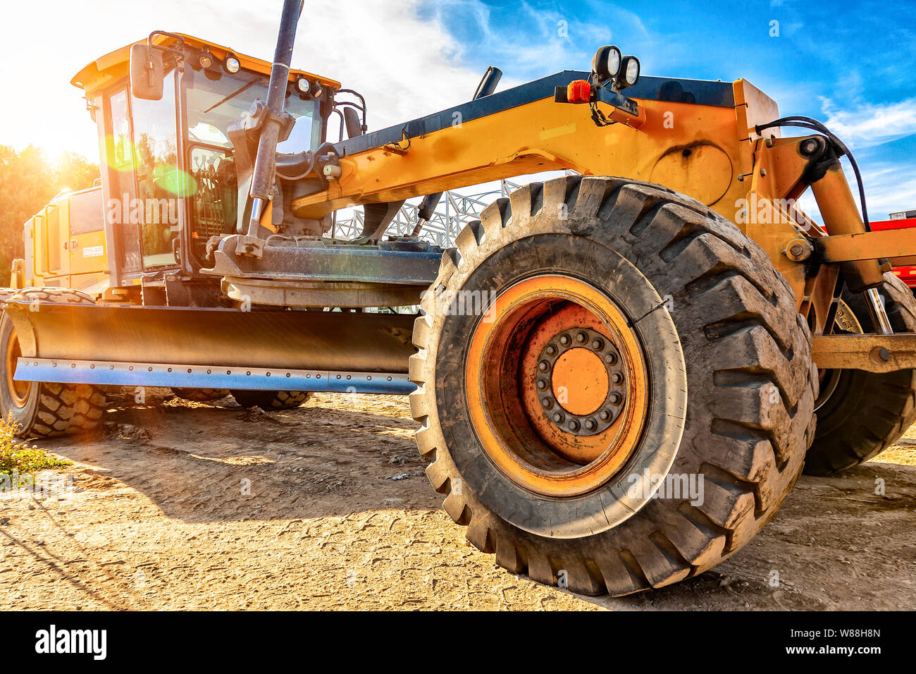 Grader leveling gravel on road construction site Stock Photo Alamy