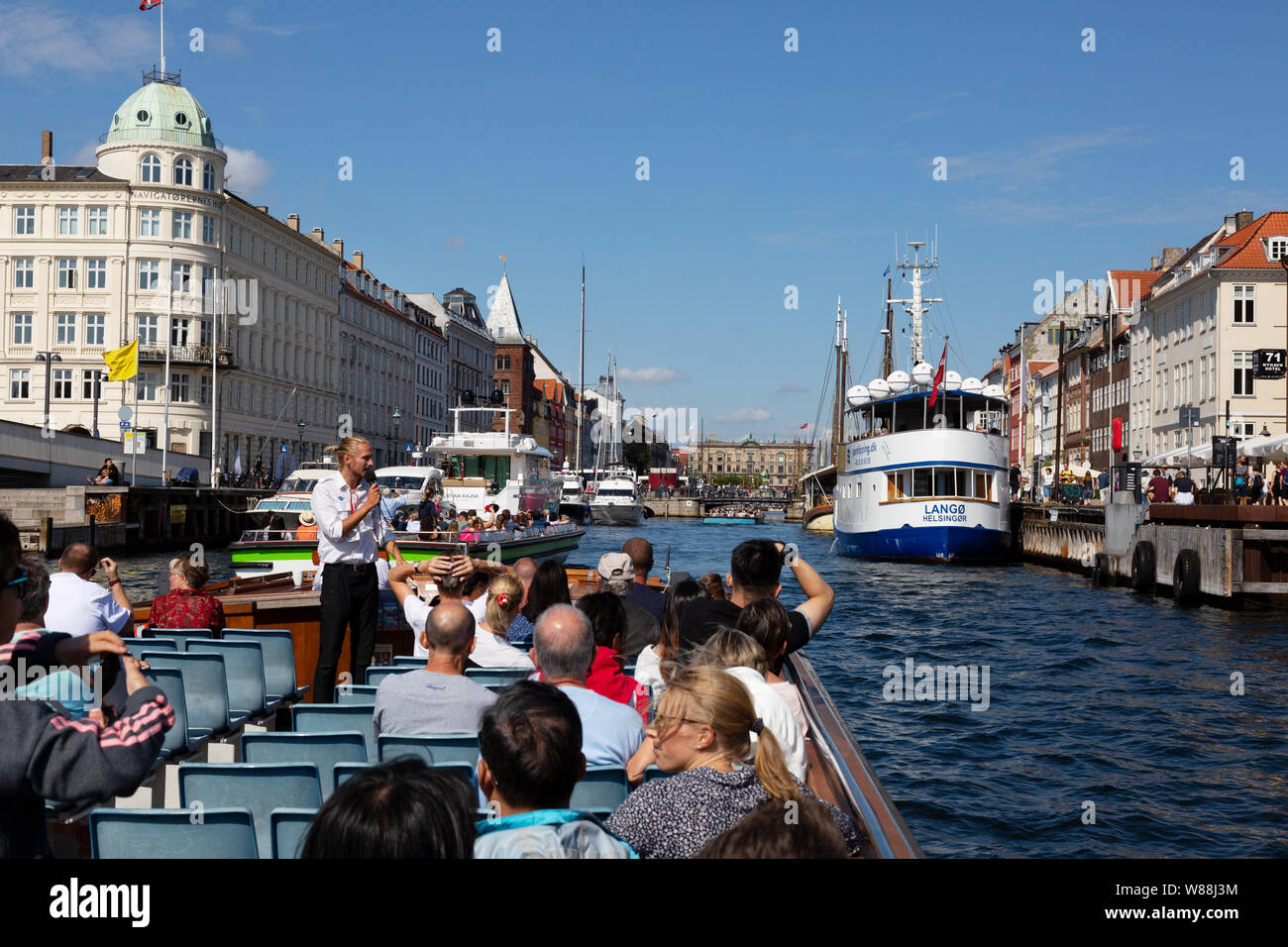 Copenhagen boat tour - people on holiday, on a guided canal tour in Summer,  Nyhavn Copenhagen Denmark Scandinavia Stock Photo