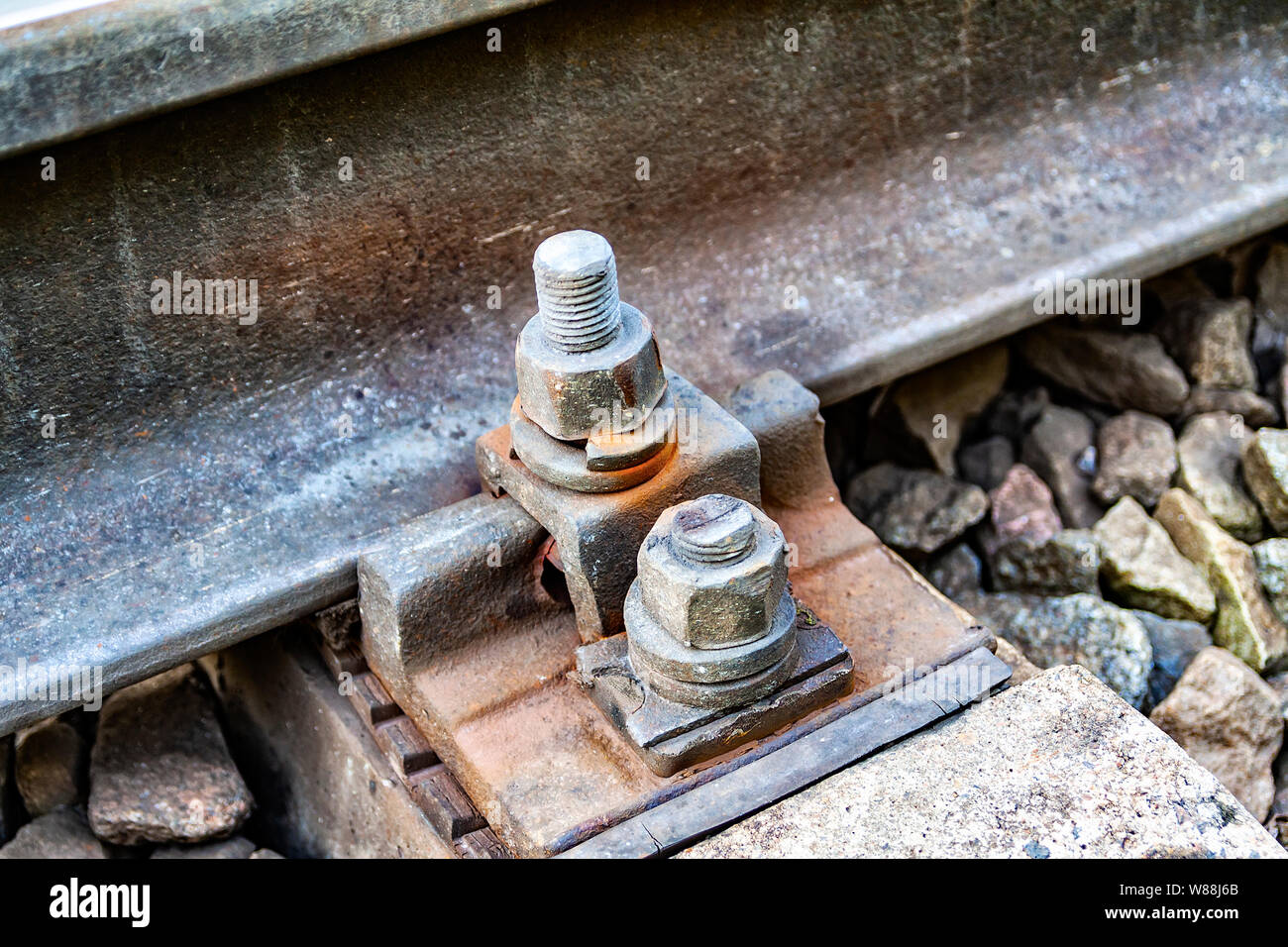 Old rust bolts for mounting rails on railroad track. Reliability of
