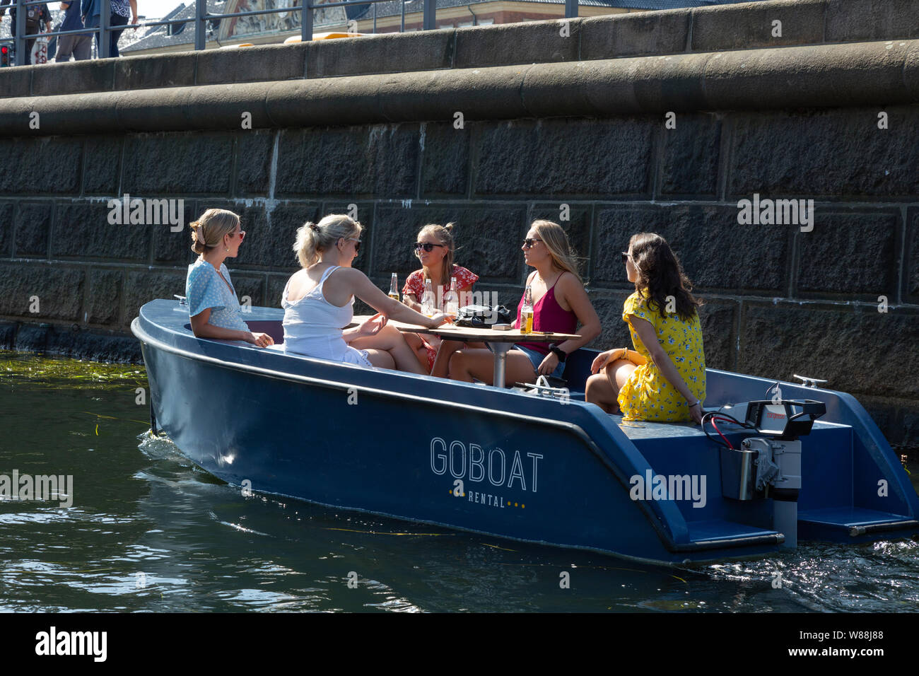 Denmark Copenhagen canal - a hire boat with a group of women relaxing on a canal trip, Copenhagen, Denmark Scandinavia Europe Stock Photo