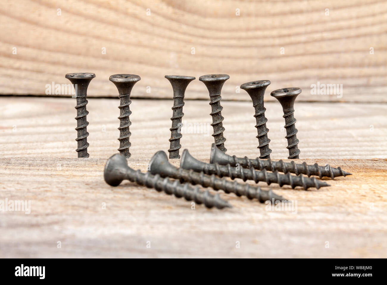 Selftapping screws, screwed in and lying on wooden planks Stock Photo